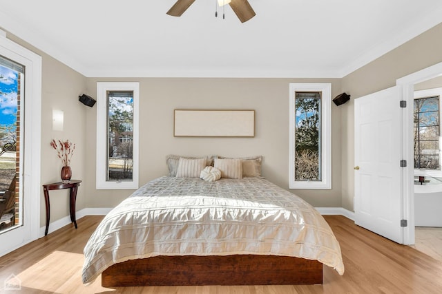 bedroom featuring light wood-style floors, ceiling fan, and baseboards