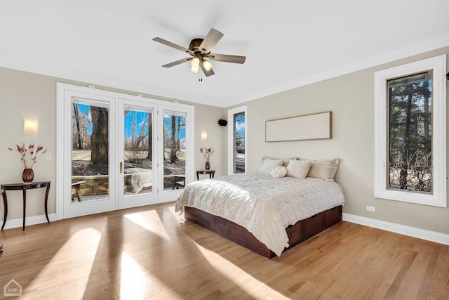 bedroom featuring access to exterior, light wood-type flooring, baseboards, and a ceiling fan