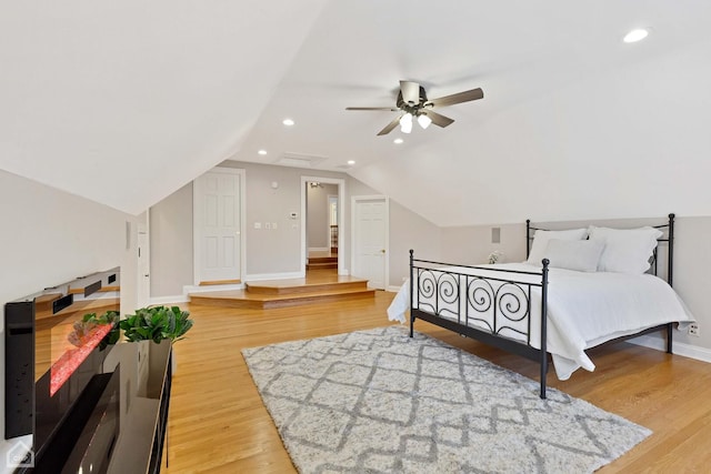 bedroom with ceiling fan, recessed lighting, baseboards, vaulted ceiling, and light wood-style floors