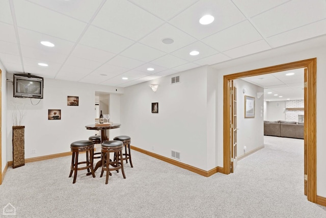 dining room with carpet floors, visible vents, and baseboards