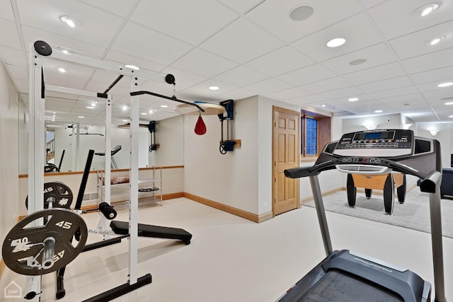 exercise room featuring recessed lighting, a drop ceiling, and baseboards