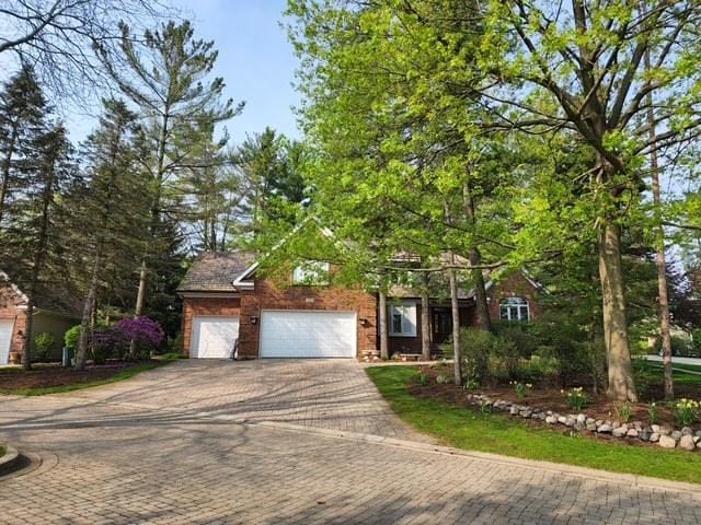 view of front of house with a garage and decorative driveway