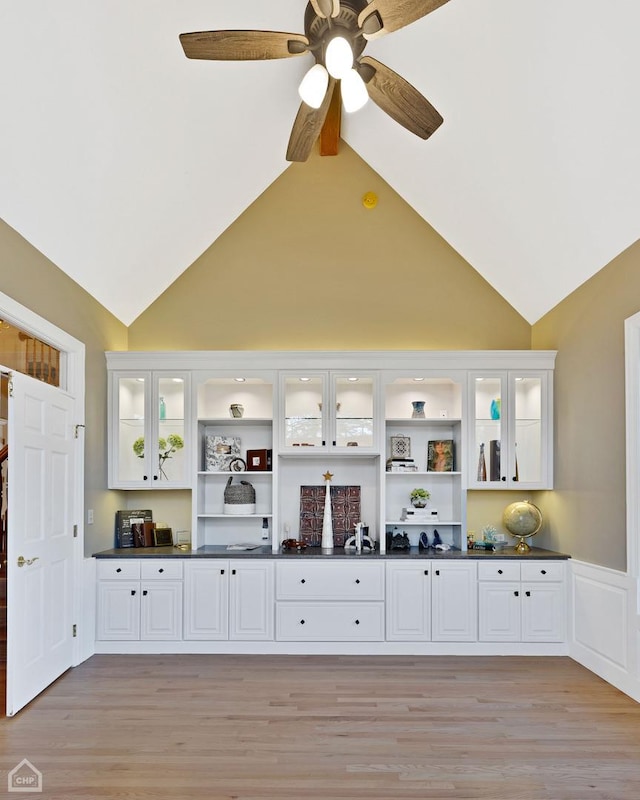 interior space with high vaulted ceiling, light wood-type flooring, and ceiling fan