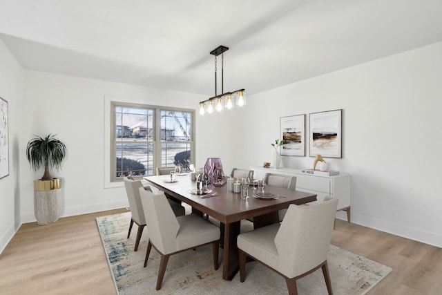 dining room with light wood-type flooring and baseboards