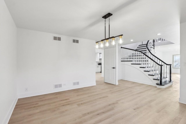 interior space featuring stairs, wood finished floors, and visible vents