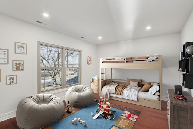 bedroom with recessed lighting, visible vents, baseboards, and wood finished floors