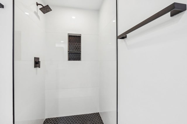 full bath with a tile shower