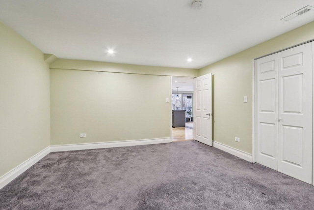 unfurnished bedroom featuring baseboards, visible vents, carpet flooring, and recessed lighting