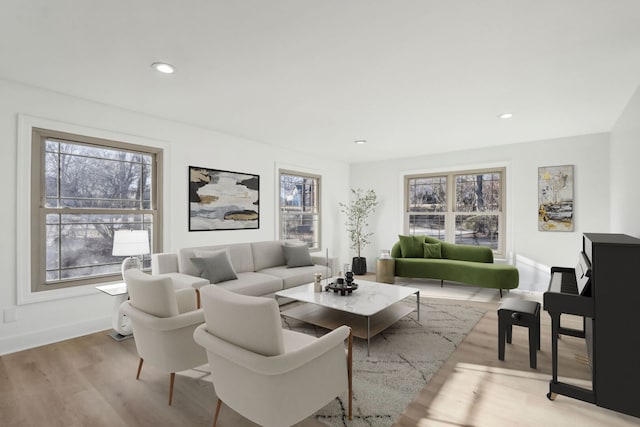 living room with a wealth of natural light, baseboards, recessed lighting, and wood finished floors