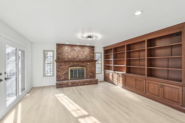 unfurnished living room featuring visible vents, a fireplace, light wood-style flooring, and recessed lighting