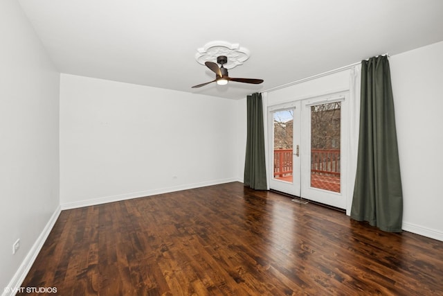 spare room featuring french doors, wood finished floors, a ceiling fan, and baseboards