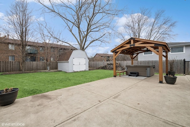 view of patio / terrace with a fenced backyard, a storage shed, an outdoor structure, a gazebo, and a hot tub