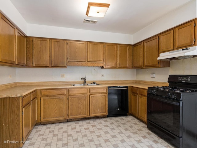 kitchen with visible vents, black appliances, under cabinet range hood, a sink, and light floors