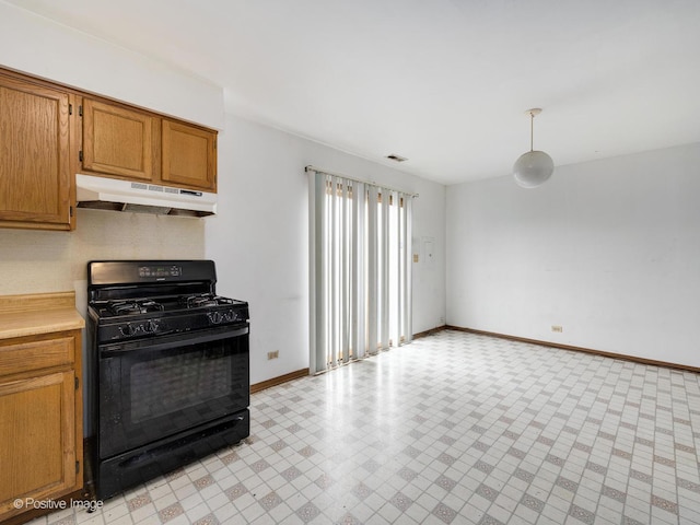 kitchen with black gas range oven, visible vents, baseboards, light countertops, and under cabinet range hood