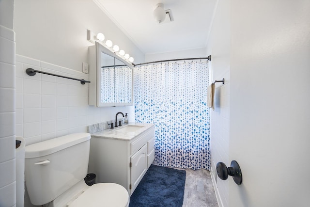 full bath featuring curtained shower, toilet, vanity, tile walls, and ornamental molding