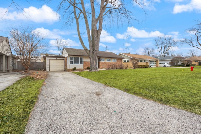 single story home with driveway, an attached garage, fence, a front lawn, and brick siding