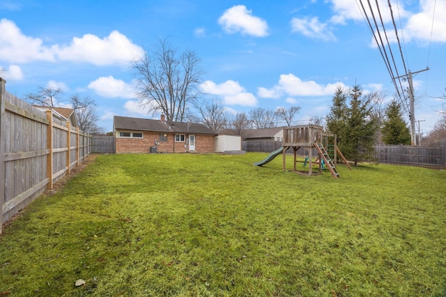 view of yard featuring a fenced backyard and a playground