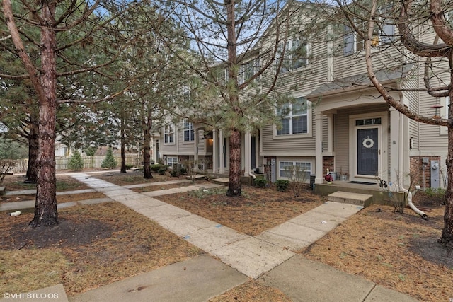 townhome / multi-family property featuring brick siding