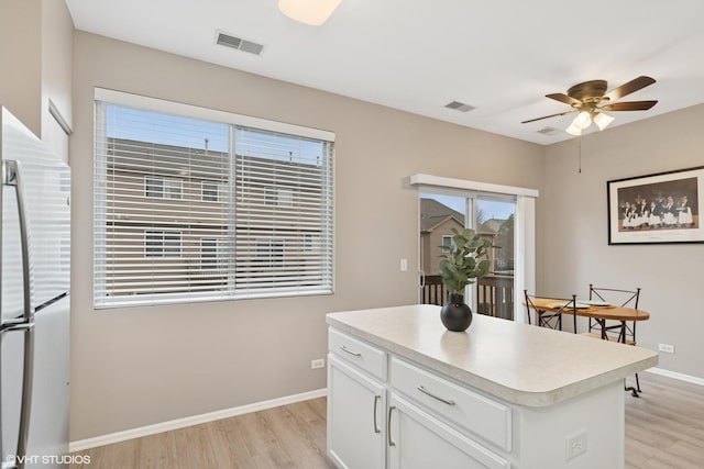 kitchen with visible vents, freestanding refrigerator, and light wood-style floors