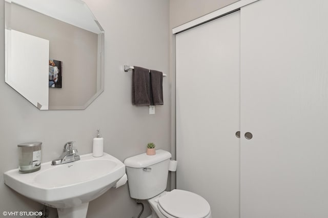 bathroom with toilet and a sink