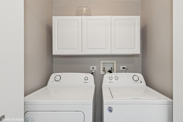 laundry area featuring separate washer and dryer and cabinet space