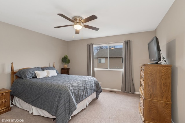 bedroom with baseboards, ceiling fan, visible vents, and light colored carpet