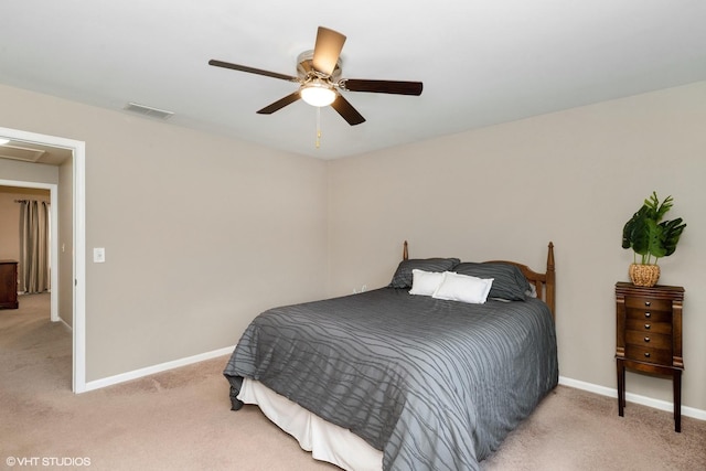 bedroom with a ceiling fan, light carpet, visible vents, and baseboards