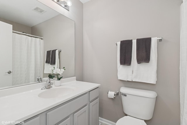 full bathroom featuring visible vents, vanity, and toilet