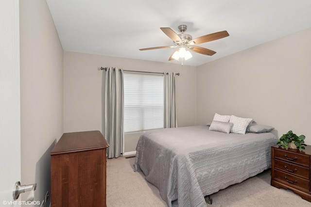 bedroom featuring ceiling fan and light colored carpet