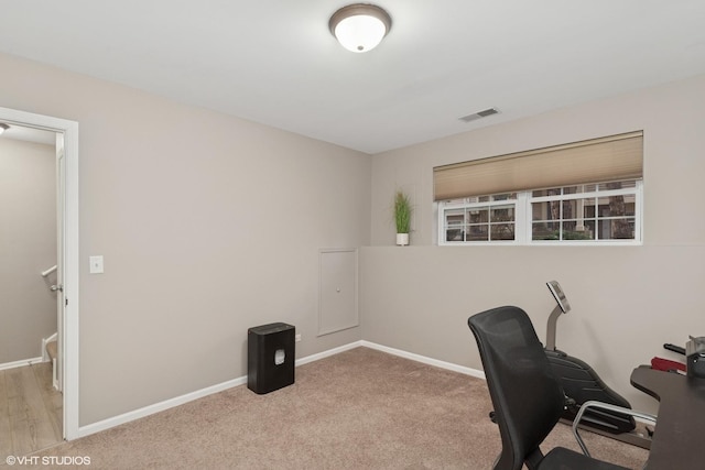 unfurnished office featuring carpet flooring, visible vents, and baseboards