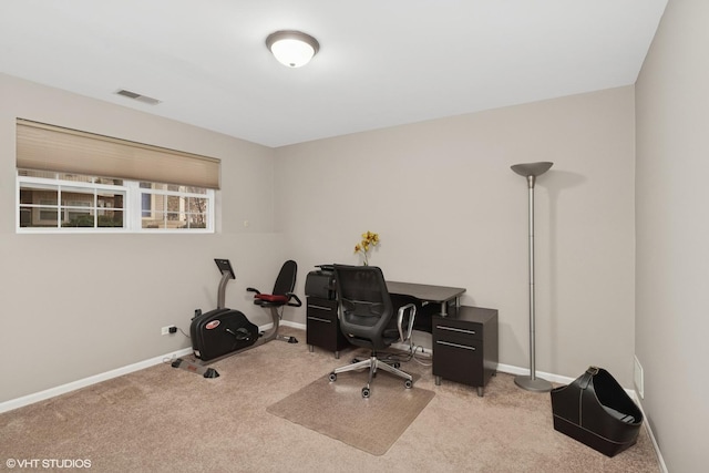 carpeted home office featuring visible vents and baseboards