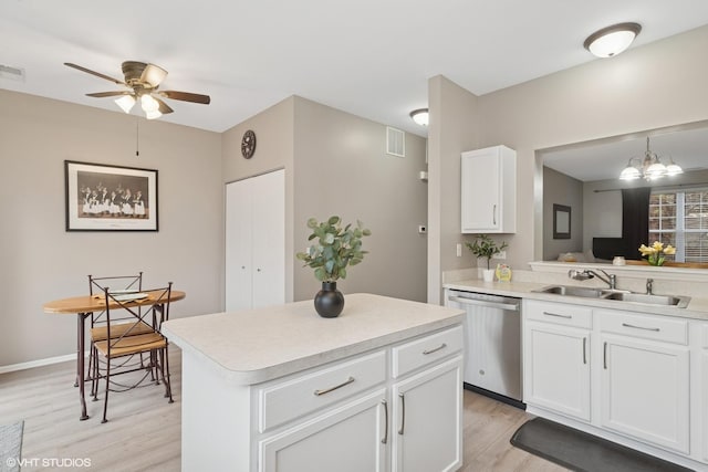 kitchen with light countertops, visible vents, light wood-style floors, a sink, and dishwasher