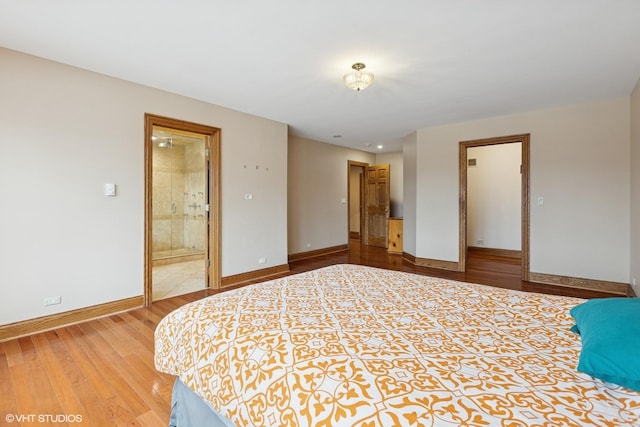 unfurnished bedroom with light wood-style floors, connected bathroom, and baseboards