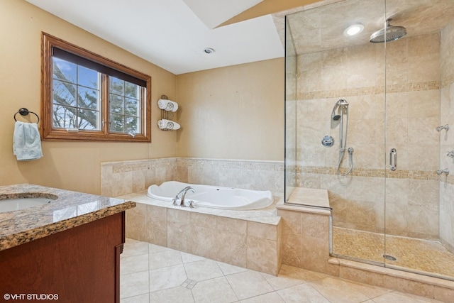 full bath with a stall shower, a garden tub, vanity, and tile patterned floors