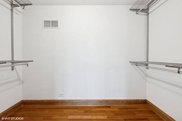 spacious closet with visible vents and wood finished floors