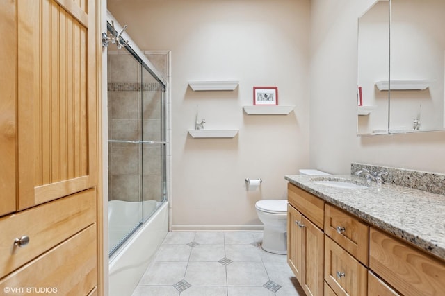 full bath featuring toilet, combined bath / shower with glass door, vanity, tile patterned flooring, and baseboards