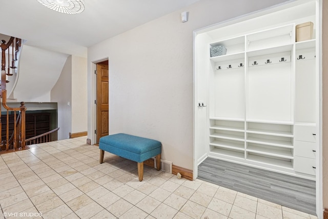 sitting room with stairway and baseboards