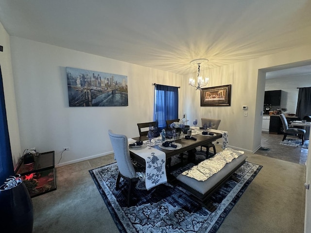 carpeted dining space featuring baseboards and a chandelier