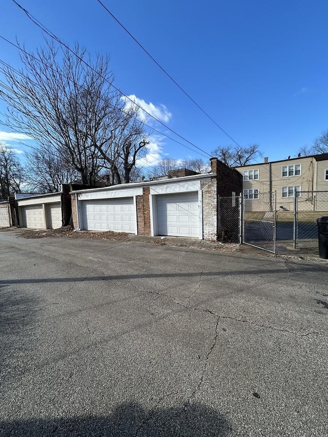 garage with a gate and fence