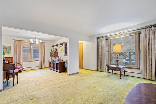 sitting room featuring a baseboard heating unit, carpet, and plenty of natural light