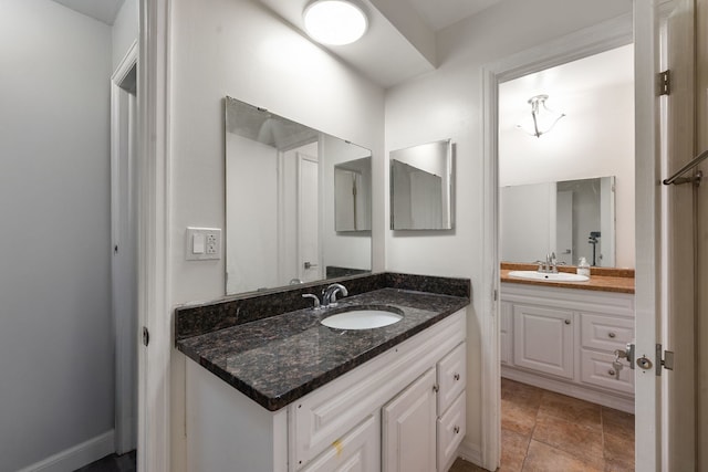 bathroom with two vanities and a sink