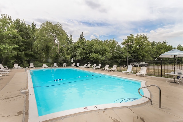 pool featuring a patio area and fence