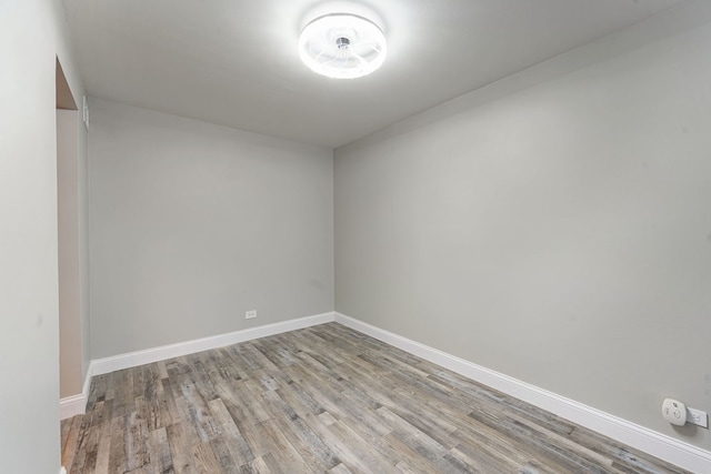 spare room with wood finished floors and baseboards