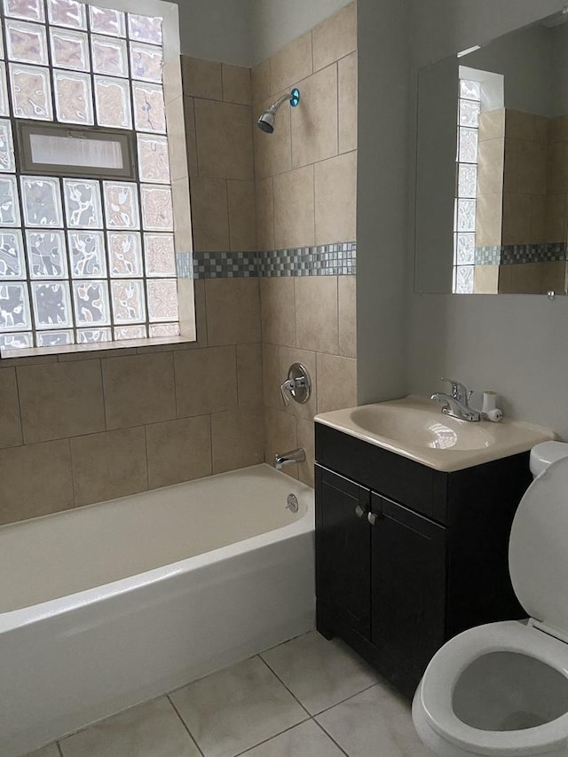 full bathroom with tile patterned floors, a healthy amount of sunlight, toilet, and bathtub / shower combination