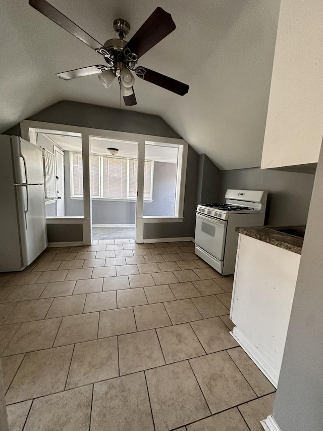 kitchen with light tile patterned floors, white appliances, a ceiling fan, and vaulted ceiling