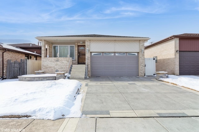 view of front facade featuring concrete driveway, brick siding, fence, and an attached garage