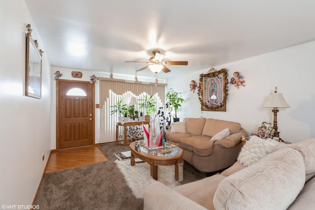 living area with a ceiling fan and wood finished floors