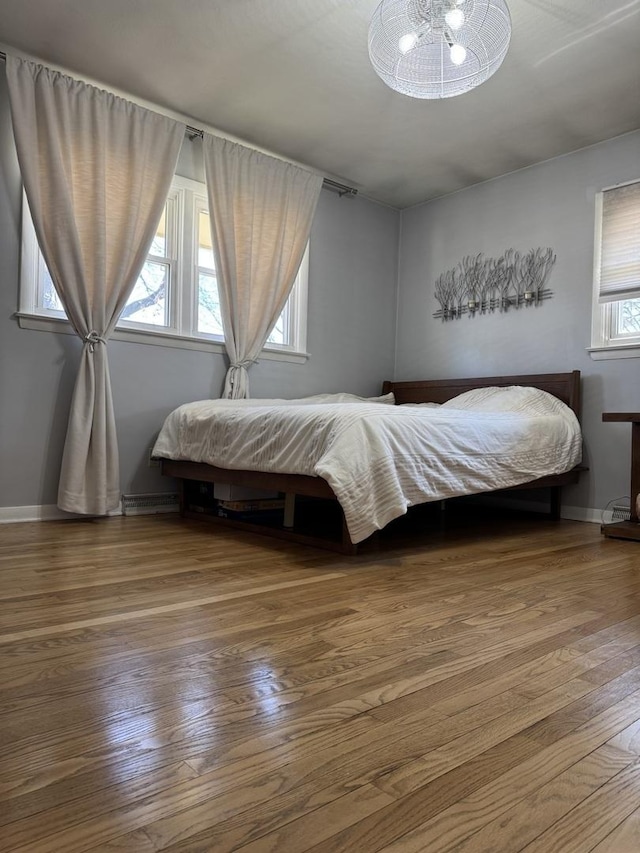 bedroom featuring baseboards and wood finished floors