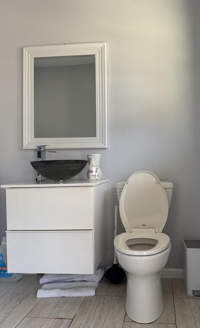 bathroom featuring toilet and vanity