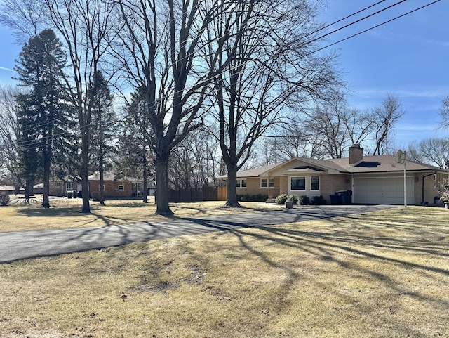 view of yard featuring an attached garage and driveway